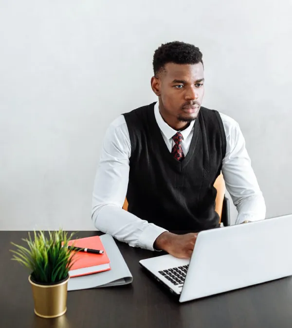 train to invest. Online Class, Training, A man infront of a laptop